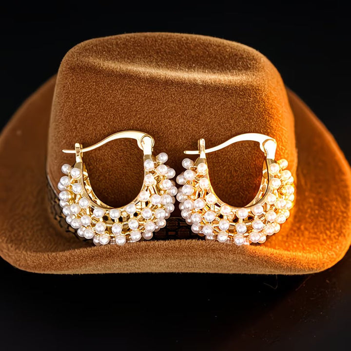 Close-up of pearls clustered along the chunky hoop earring