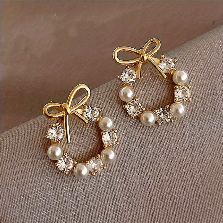 Earrings laid flat on a neutral background