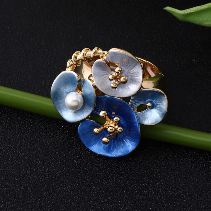 Close-up of the blue enamel petals surrounding the pearl
