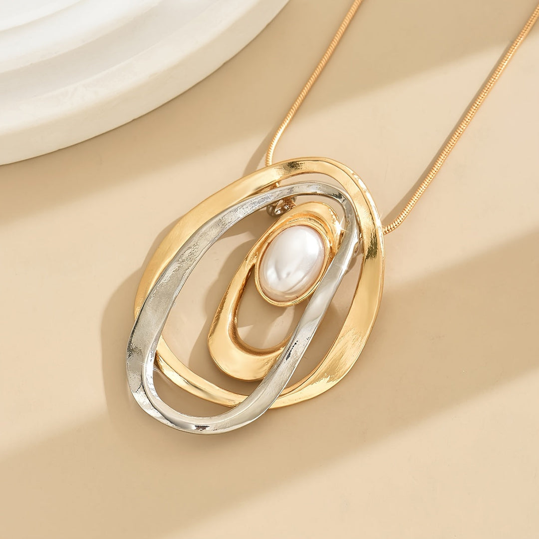 Statement pearl geometric pendant necklace on a white background