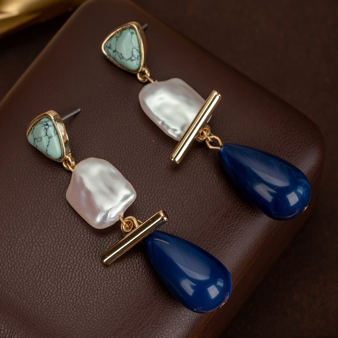Luxe turquoise pearl drop earrings on a white background