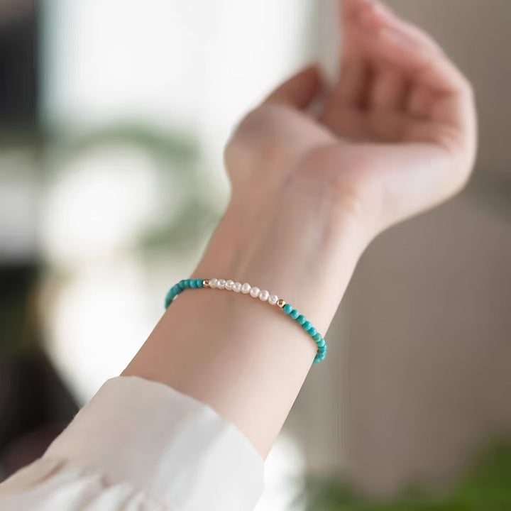 Lifestyle shot of the bracelet stacked with other jewellery