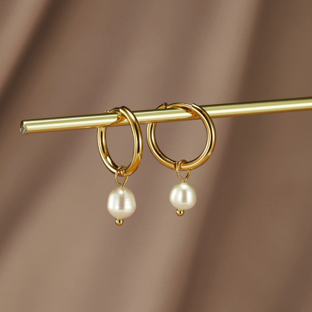 Freshwater pearl hoop earrings shown together on a white background
