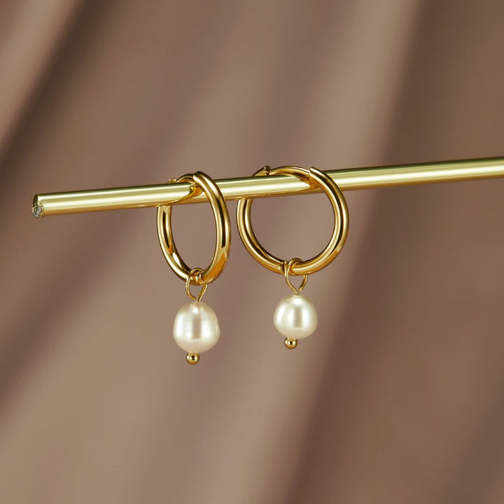 Freshwater pearl hoop earrings shown together on a white background