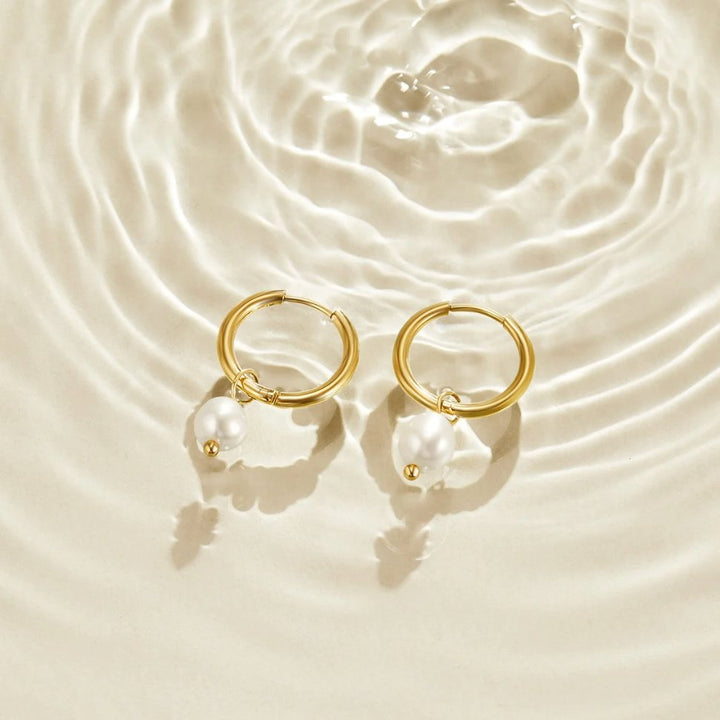 Angled close-up highlighting the pearl and hoop craftsmanship