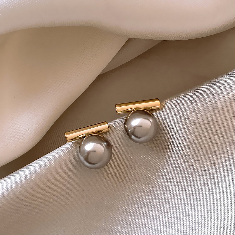 Deep pearl drop earrings shown on a white background