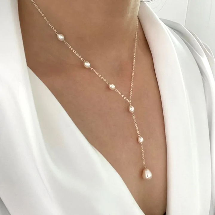 Model wearing the pearl lariat necklace tied in a cascading knot