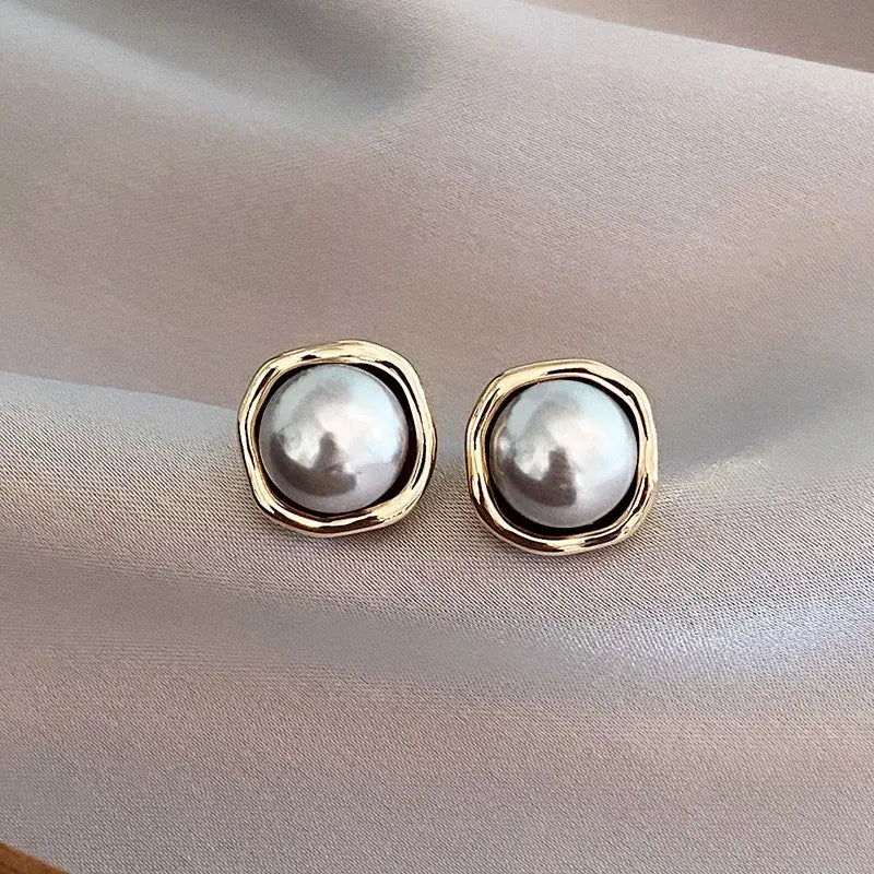 Luxe black pearl stud earrings shown in close-up product view