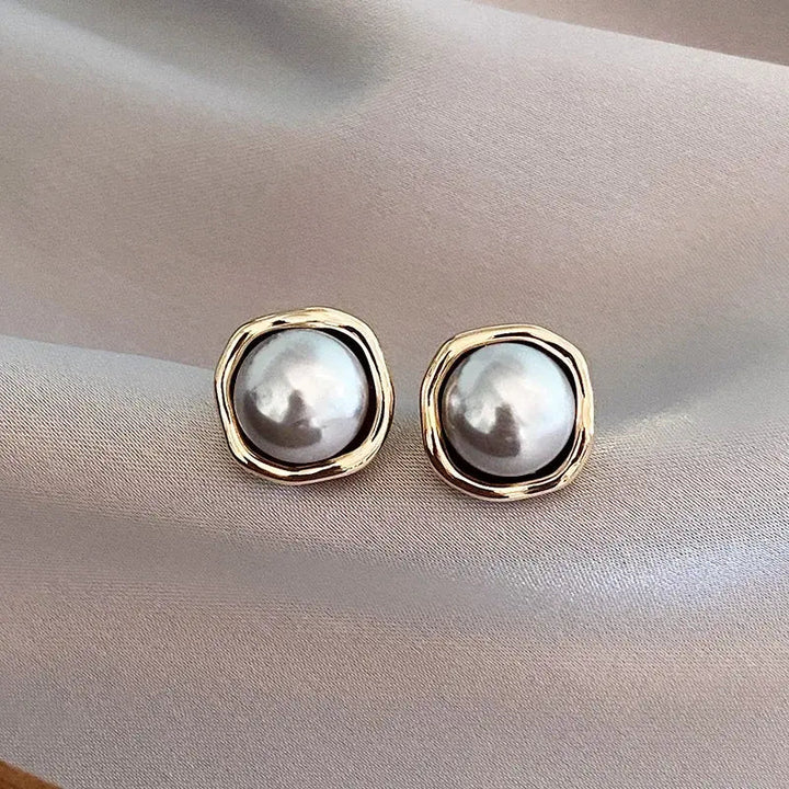 Luxe black pearl stud earrings shown in close-up product view