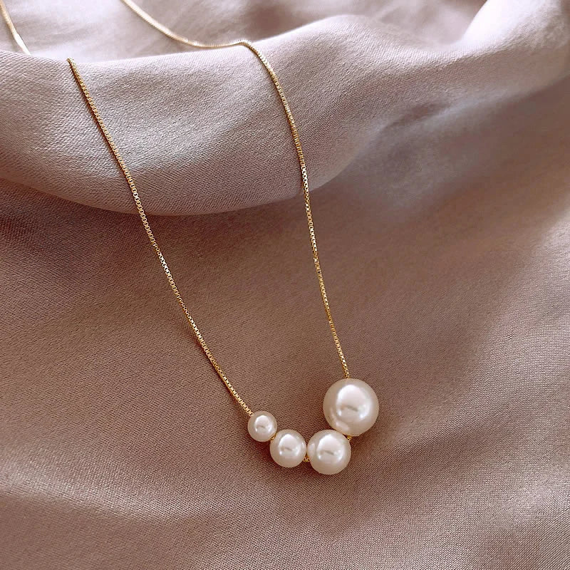 Magic pearl cluster necklace laid out on a neutral background