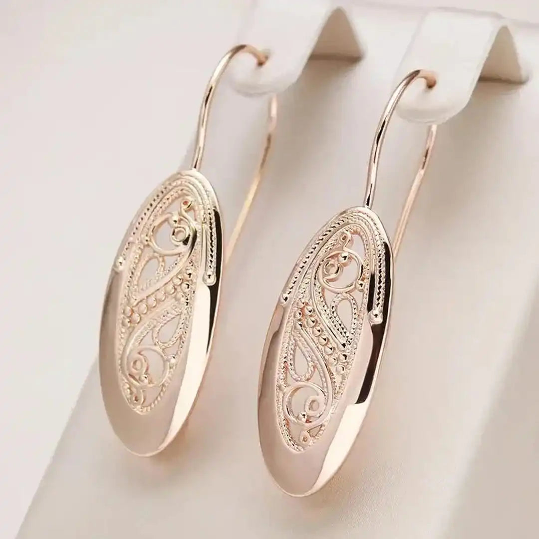 Main shot of the open teardrop gold drop earrings