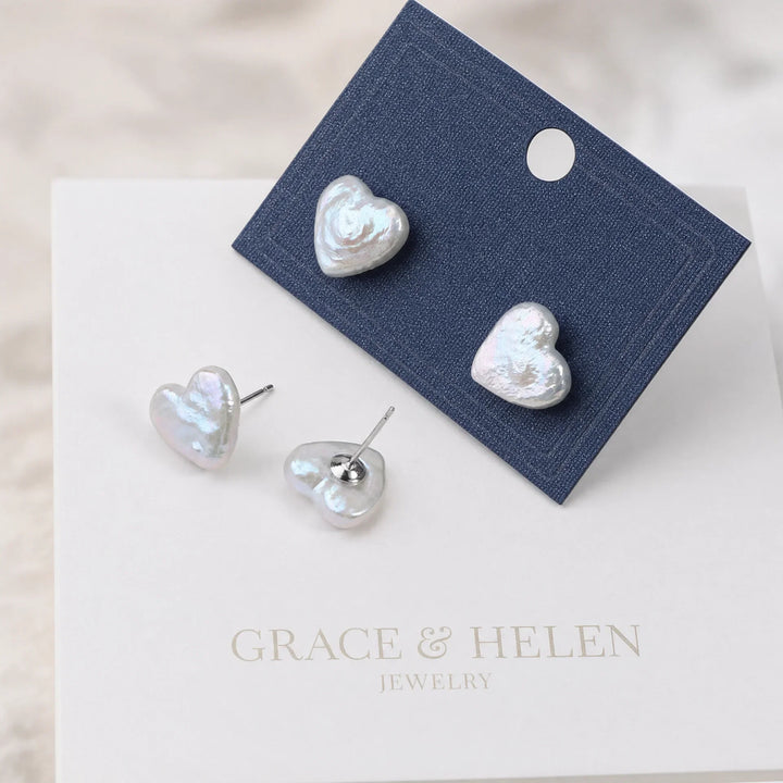 Freshwater pearl heart drop earrings shown on a plain background