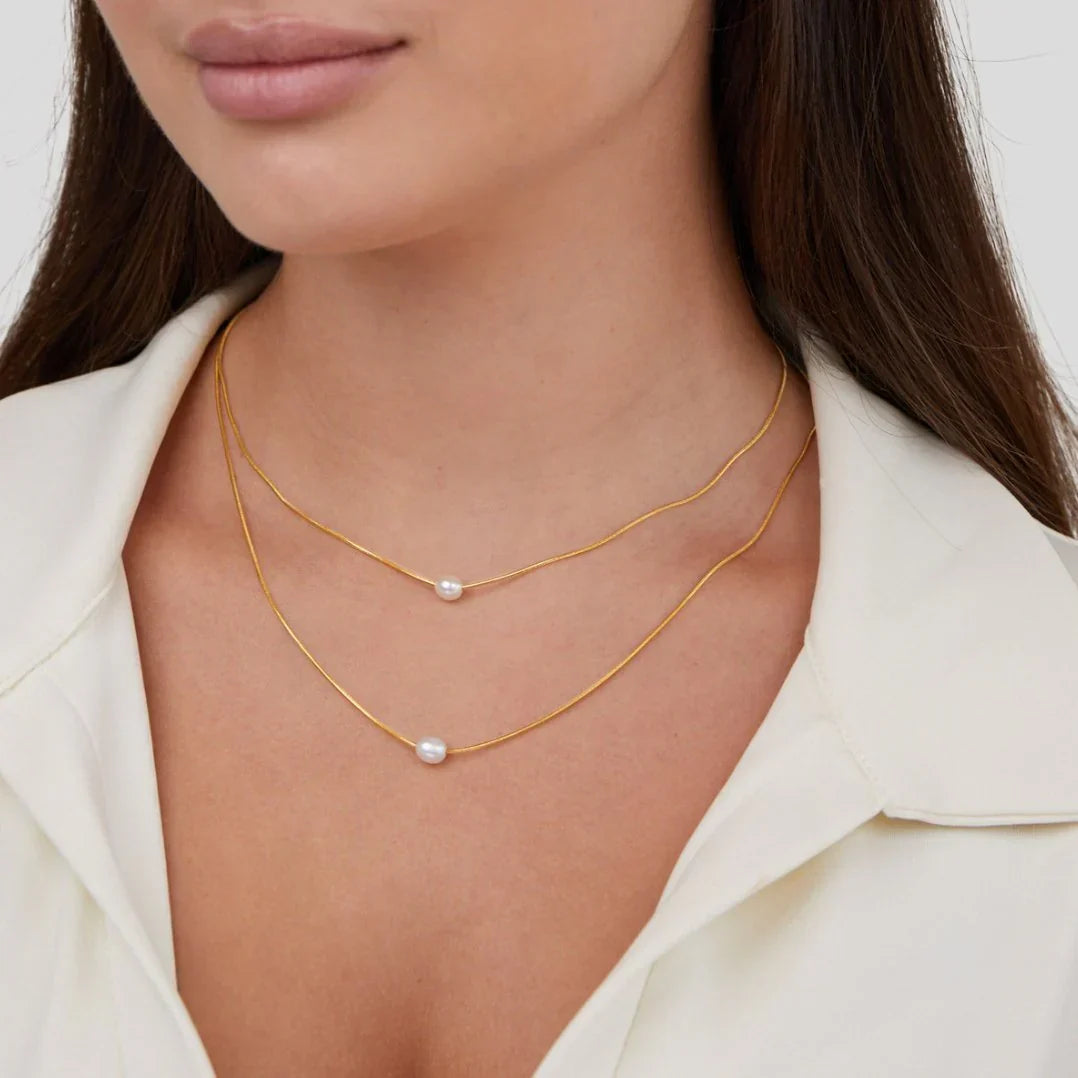 Layered pearl necklace styled with a coordinating outfit