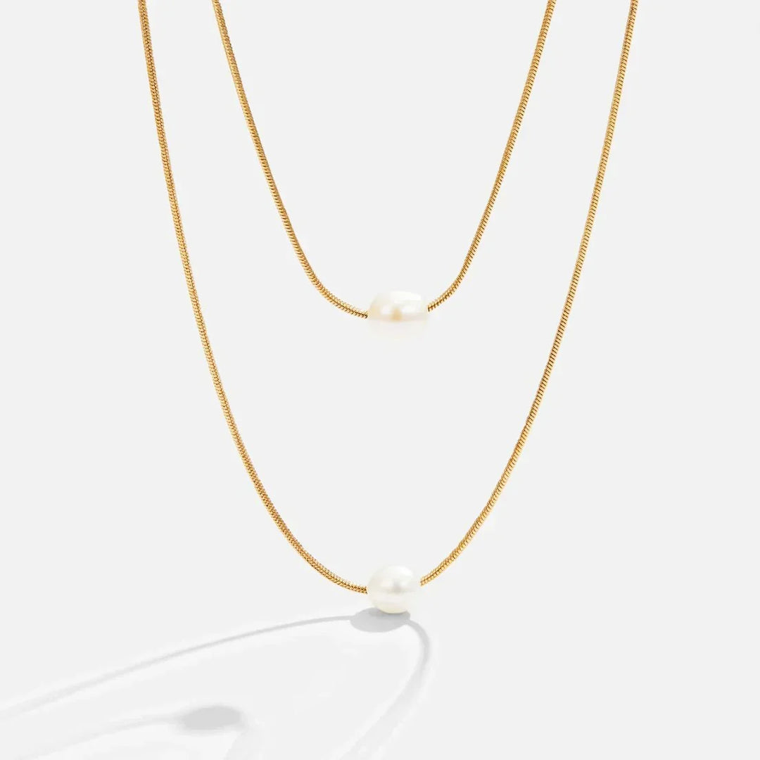 Layered pearl necklace photographed against a plain background