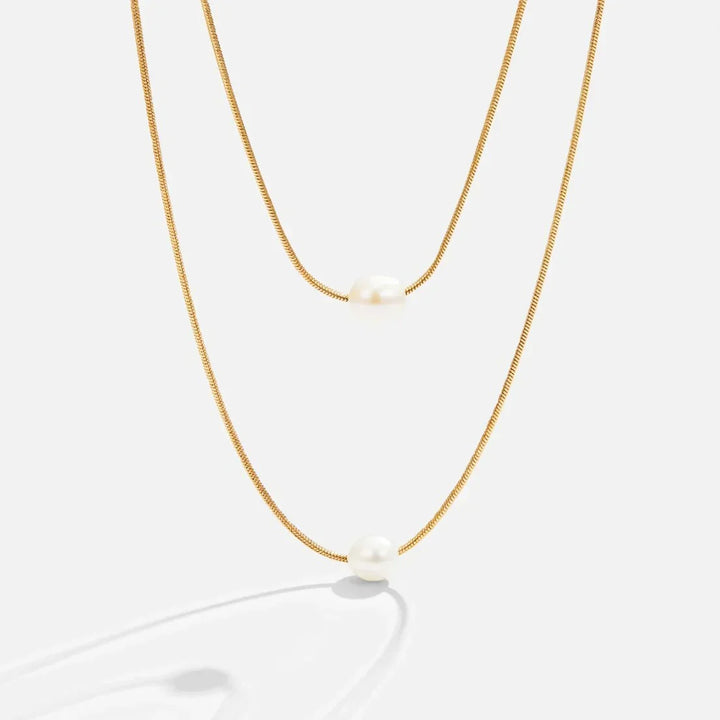 Layered pearl necklace photographed against a plain background