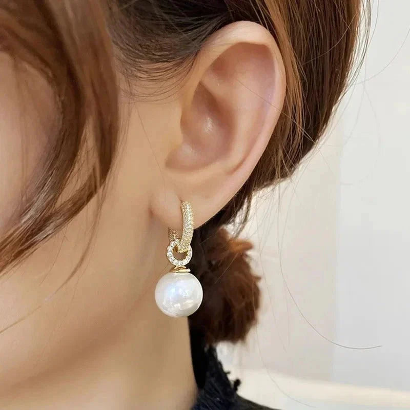 Dazzling pearl earrings styled next to complementary jewellery