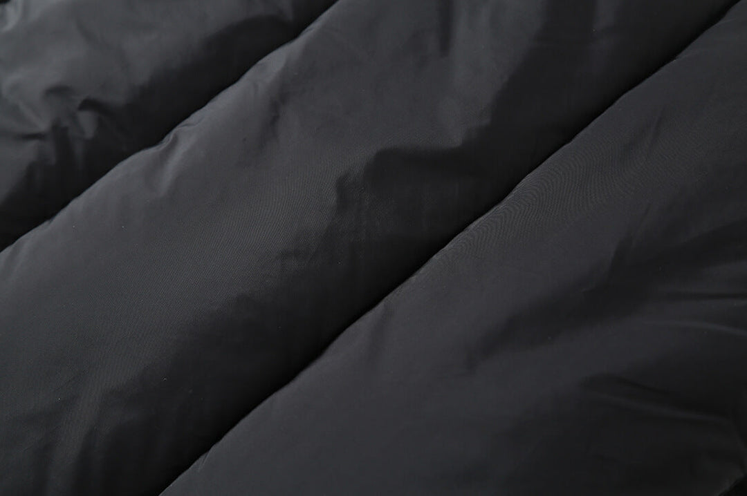 Close-up of the plaid puffer jacket's quilted fill