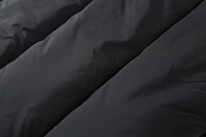 Close-up of the plaid puffer jacket's quilted fill