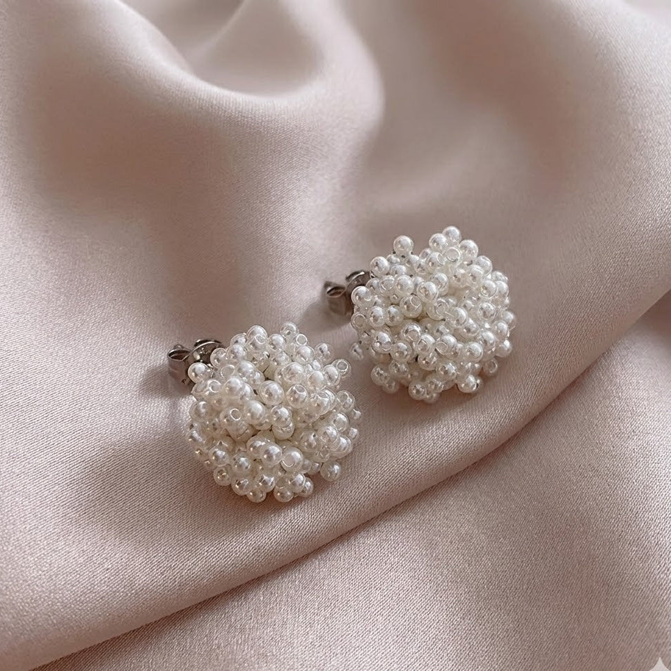 Classic inlaid pearl earrings shown on a white background