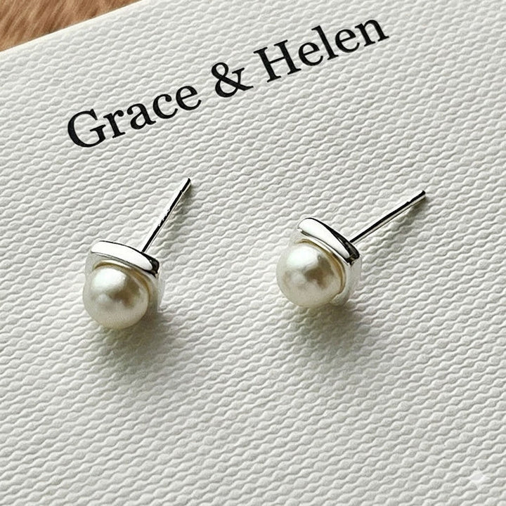 Classic freshwater pearl drop earrings photographed from an angle
