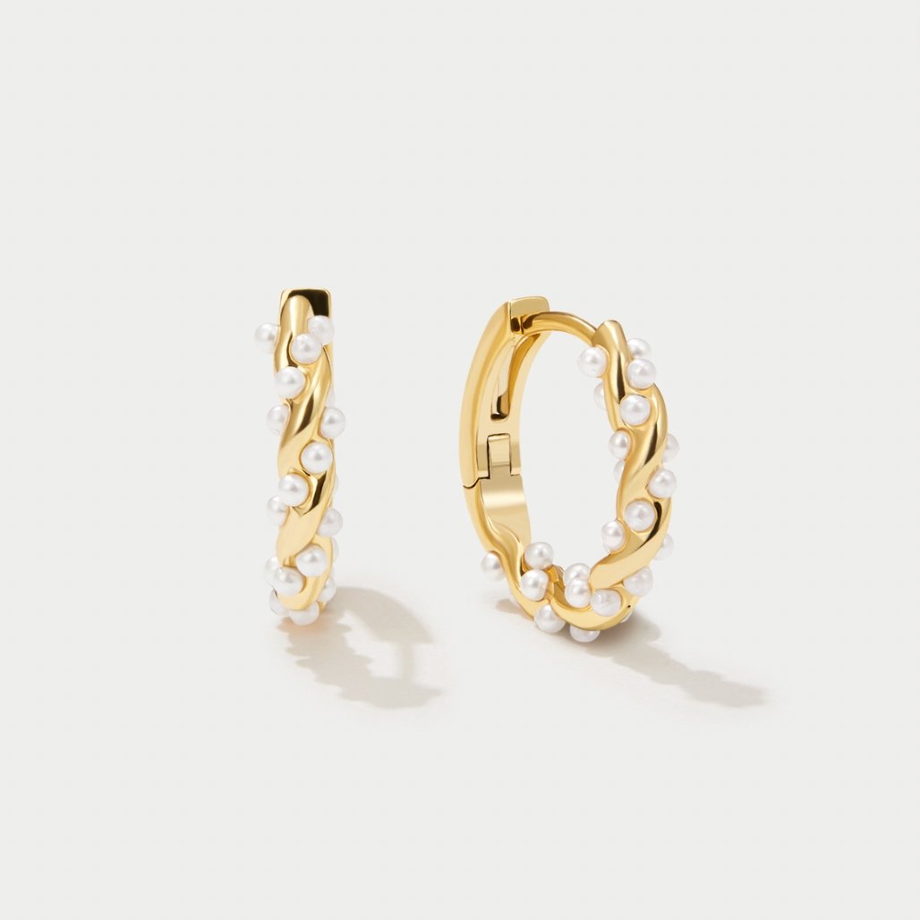 Model wearing the twirled pearl hoop earrings