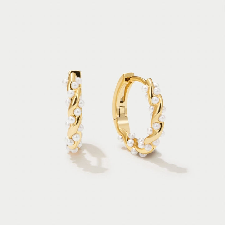 Model wearing the twirled pearl hoop earrings